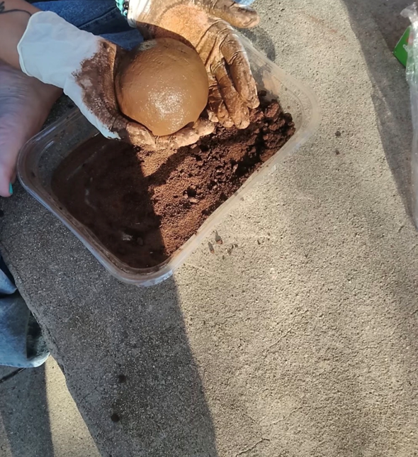 Forming a rough sphere over a tub of earth
